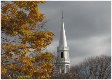 Church steeple with autumn leaves.